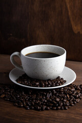 Coffe cup with milk and coffee grains