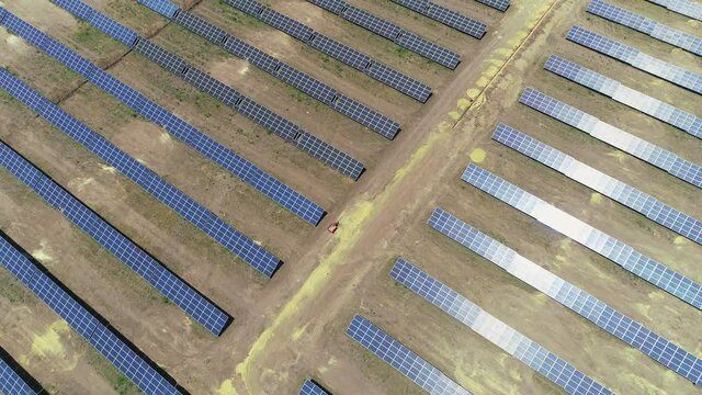 Fly over a field of solar panels