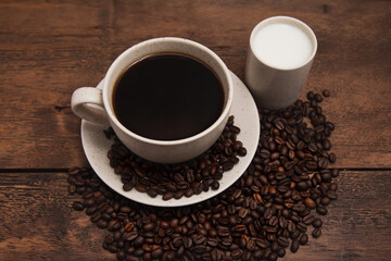 Obraz na płótnie Canvas Coffe cup with milk and coffee grains