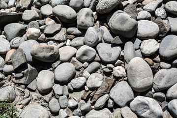 A cluster of pebbles of different sizes and shapes on a dried up river bed in the Himalayas.