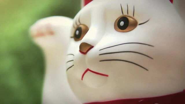 Japanese Lucky Cat Figurine Waving Paw Outside, Detailed Close Up, 4K