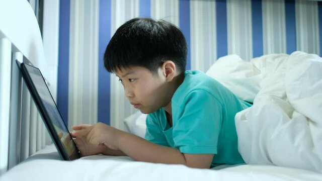 asian chinese boy playing smartphone, kid use phone and play game, addicted game and cartoon
