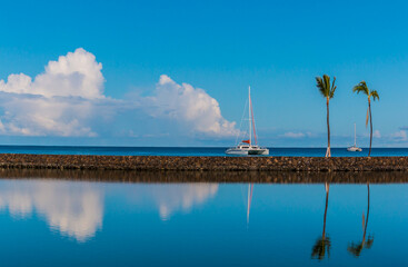 Sailboat and Palm Trees Reflecting In The Lagoons at Waikoloa Beach, Hawaii, Hawaii, USA