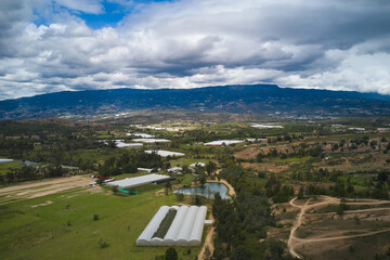 Fototapeta na wymiar Aerial view of hydroponics with surrounding water ponds in a countryside landscape in Boyaca. Colombia.