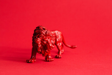 Red lion figure on the red background. Protect wild animals poster.	
