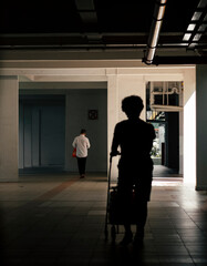 Pushing groceries cart at void deck of HDB flat