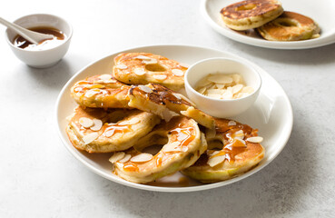 Fresh baked pancakes with apple, honey and almond close up