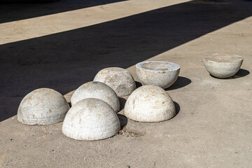 Fototapeta na wymiar Stone (concrete) hemispheres for traffic restriction are piled up