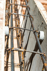 The rounded concrete rebar chair for supporting rebar to make correct alignment before pouring concrete of a house foundation.