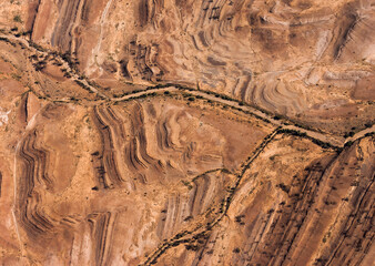 A dry creek winding through land formations in central Australia