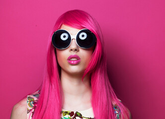 Pretty woman in pink wig and big funny sunglasses