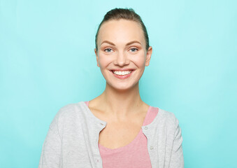 Lifestyle, emotion and people concept: Young cute smiling blond woman over blue background