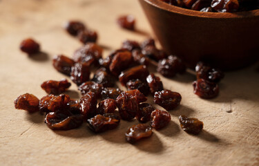 Raisins on an old wooden background.