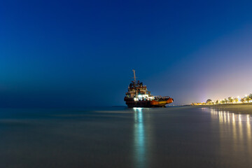 Ship Wreck along the Umm Al Quwain Coast in UAE. A stranded or abandoned vessel on the beach. Long...