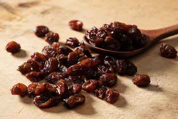 Raisins on an old wooden background.
