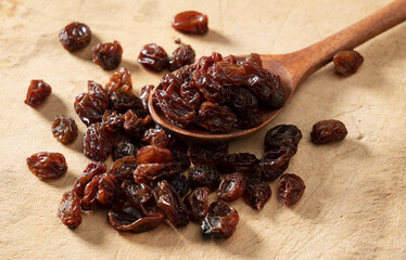 Raisins on an old wooden background.