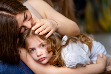 Obraz na płótnie Canvas Mom cuddles with her daughter. happy family. 