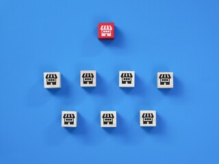 Franchise business system concept. Wooden cubes with icon store isolated on blue background.