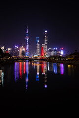 Fototapeta na wymiar Night Shanghai skyline with reflections in a river 