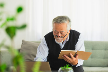 Asian Elderly man working job on computer.