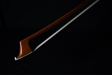 Closeup of cello bow with black background
