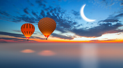 Night sky with crescent moon in the clouds with hot air balloon 