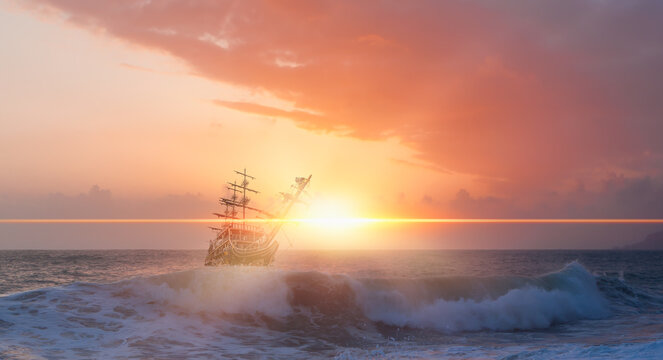 Sailing old ship in storm sea at  sunset clouds