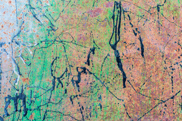 Rusty metal surface with multicolored paint splashes. Colors - green, white, black.