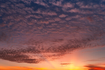 Stunning sunsets with blue, lilac, yellow and orange colors painting the sky. Amazing colorful cirrus clouds and strata, sun rays in pink, yellow, composing the scene. Iriomote Island.