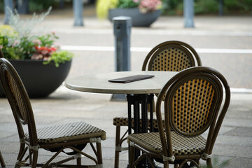 Tables and chairs in a street café in the city