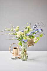 Finished flower arrangement in a vase for home. Flowers bunch, set for interior. Fresh cut flowers for decoration home. European floral shop. Delivery fresh cut flower.