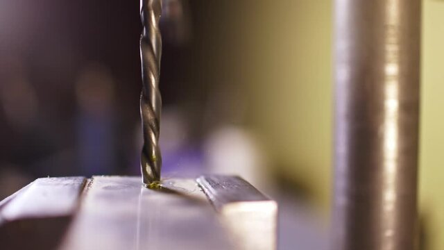 Shot of a drilling machine rotation at the workplace of a toolman locksmith, UHD 4k macro video