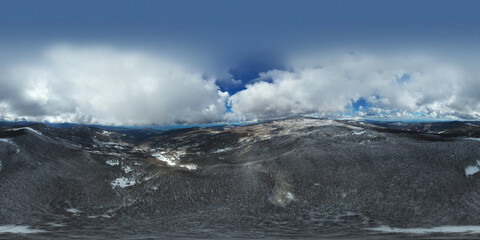360 degrees photo of the beech forest of the Nebrodi mountains in Sicily during a light snowfall in early spring. View of Etna. Monte Soro and the Aeolian Islands with the Tyrrhenian Sea. 