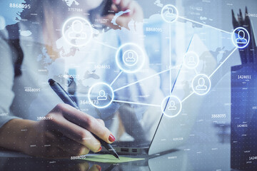 Double exposure of woman hands typing on computer and social network theme hologram drawing. People media concept.