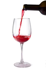Fotobehang Red wine is poured into a glass from a bottle, isolate on a white background © olga_sova