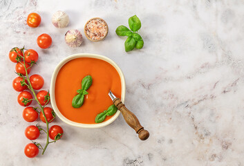 Fototapeta na wymiar Vegetarian recipe, healthy lunch. Tomato cream soup with garlic and basil. Vegetarian recipe, healthy lunch. top view, copy space