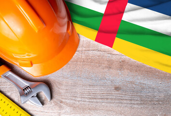 Central African Republic flag with different construction tools on wood background, with copy space for text. Happy Labor day concept.