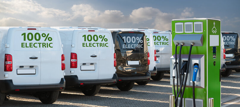 Electric vehicles charging station on a background of a row of vans. Green transportation concept	

