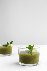 Homemade vegetable green smoothie with apple, cucumber, mint and lime