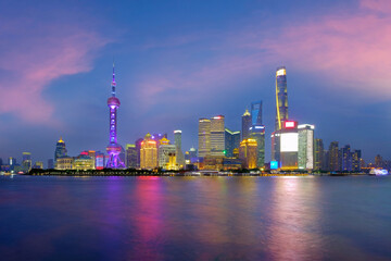 Plakat Shanghai city skyline Pudong side looking through Huangpu river on twilight time. Shanghai, China. Beutiful vibrant panoramic image.