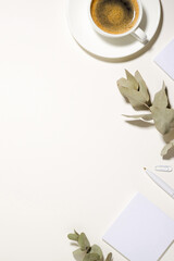 Workplace with a cup of coffee, note sheets, pen and dried flowers