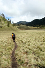 Malang, Indonesia &ndash; June 8, 2013: A group of people walking along the grasslands of Mount Semeru, East Java, Indonesia
