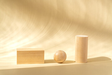 Conceptual Background with light wooden podiums and wooden ball on beige background for branding...