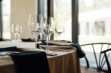 Luxurious restaurant. Luxurious interior, white tables, serving dishes and glasses for guests