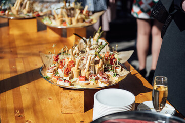 Sandwiches, canapes and cakes on the festive table. A wide variety of snacks