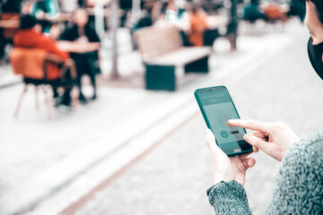 Person at the resturant using mobile app in phone to show immunization certificate.