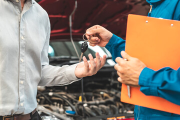 Car Mechanic Ready For Work. Auto Mechanic with Large Wrench in Hands. Ideas How to Fix the Problem.Male mechanics at the garage fixing a car.Closed up focus .