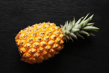 Photography of a Victoria pineapple on a slate background for food illustration