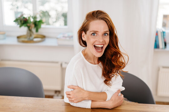 Excited young woman staring in surprise