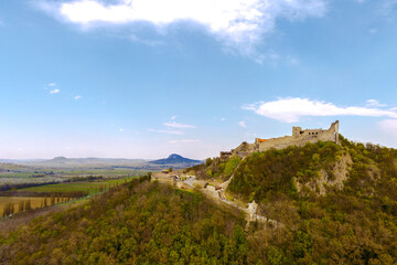 Fototapeta na wymiar The Castle of Szigliget with Badacsony mountain next to lake Balaton in Hungary. Hisorical monument fortress ruins. Built was in 11 century, destroyed in 16.
